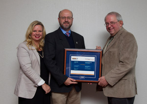 Tim McCluskey, centre, from the Department of Education and Early Childhood Development, accepts the WorkSafeNB Health and Safety Educator Award on Keith Armstrong’s behalf